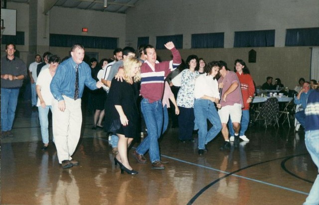 Firefighter Weer leads the line dance at the 1998 Parade Party